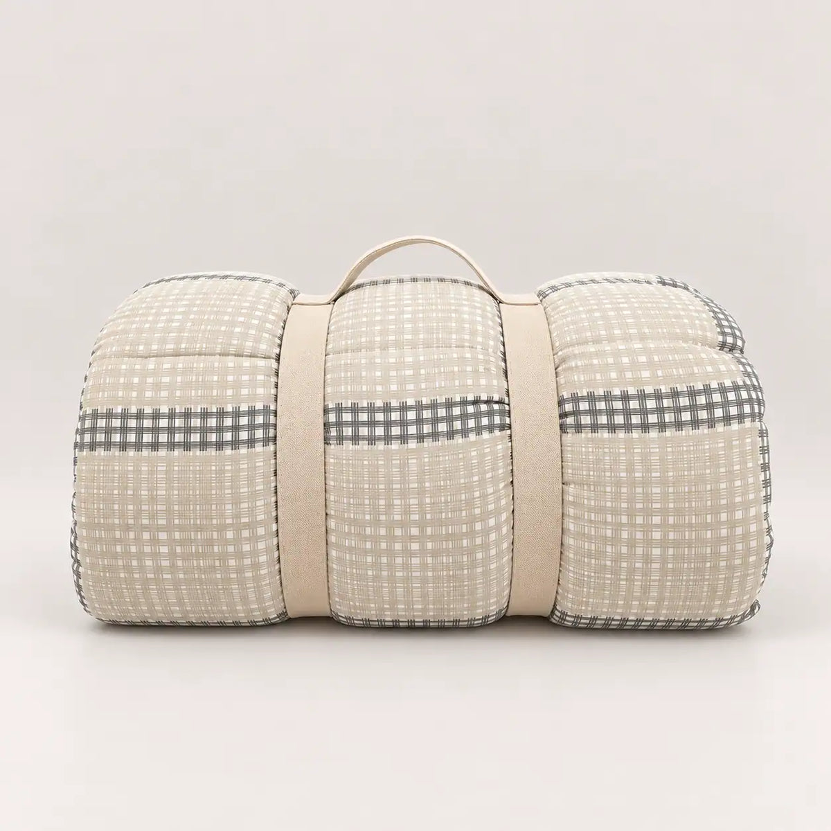 Piumone da mezza stagione con pratica maniglia per riporlo, con lato principale a quadri nei toni del beige e grigio.